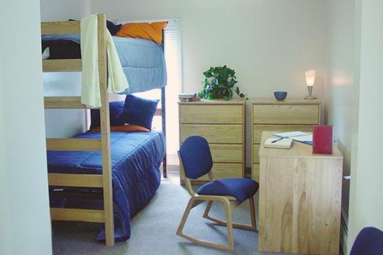 Keystone College dorm room with bunk beds two dressers and a desk
